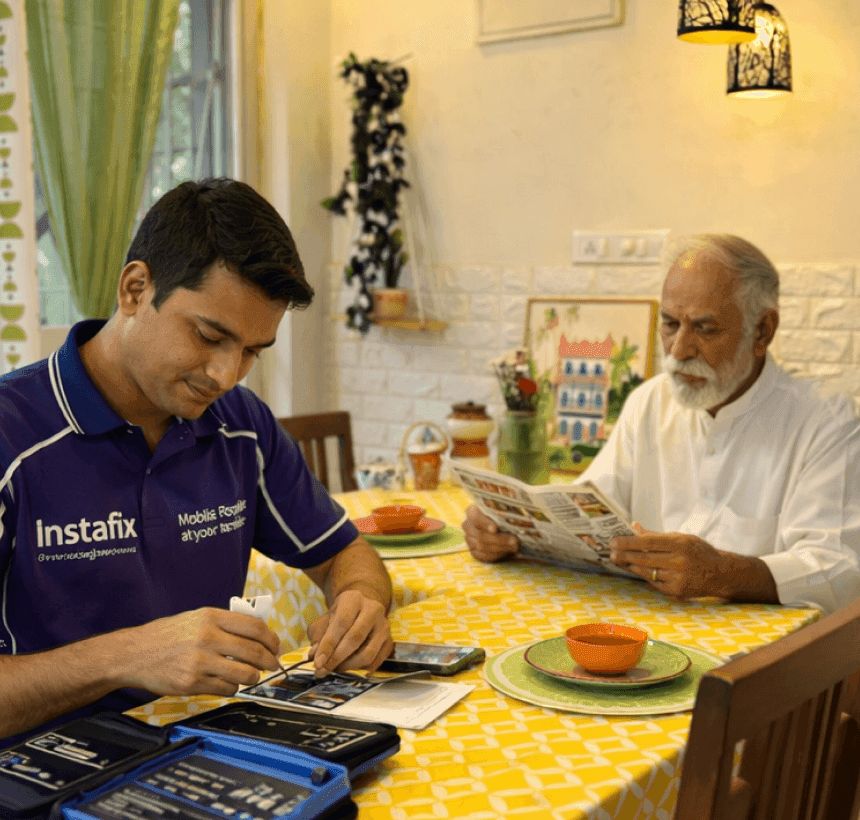 Instafix technician repairing a phone at a customer’s home