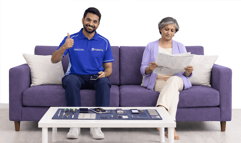 Instafix technician repairing a phone beside a customer at home