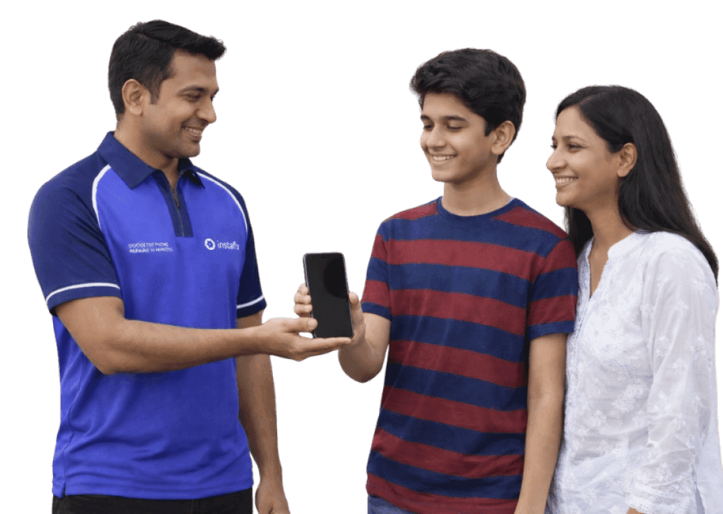 Instafix technician handing a repaired phone back to a family